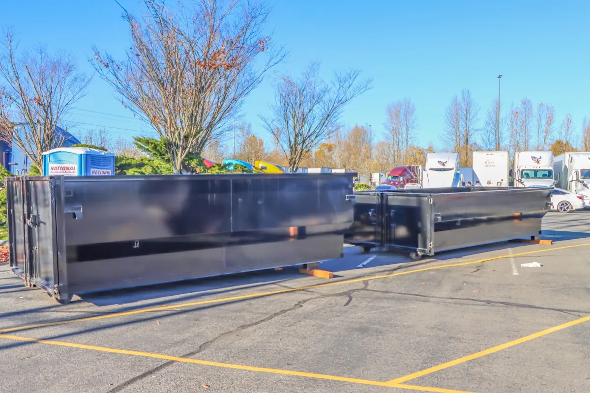 Professional dumpster rental service with roll-off container on residential driveway in Bear Valley Springs